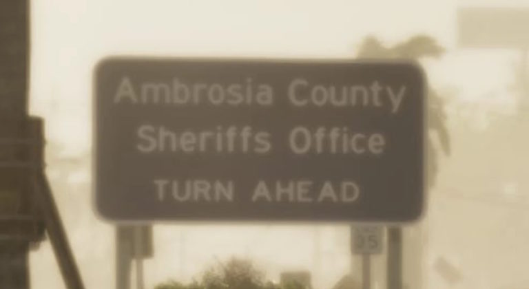 Дорожный знак с надписью Ambrosia County Sheriffs Office TURN AHEAD на фоне размытых силуэтов деревьев и зданий, ограничение скорости 35 миль в час.