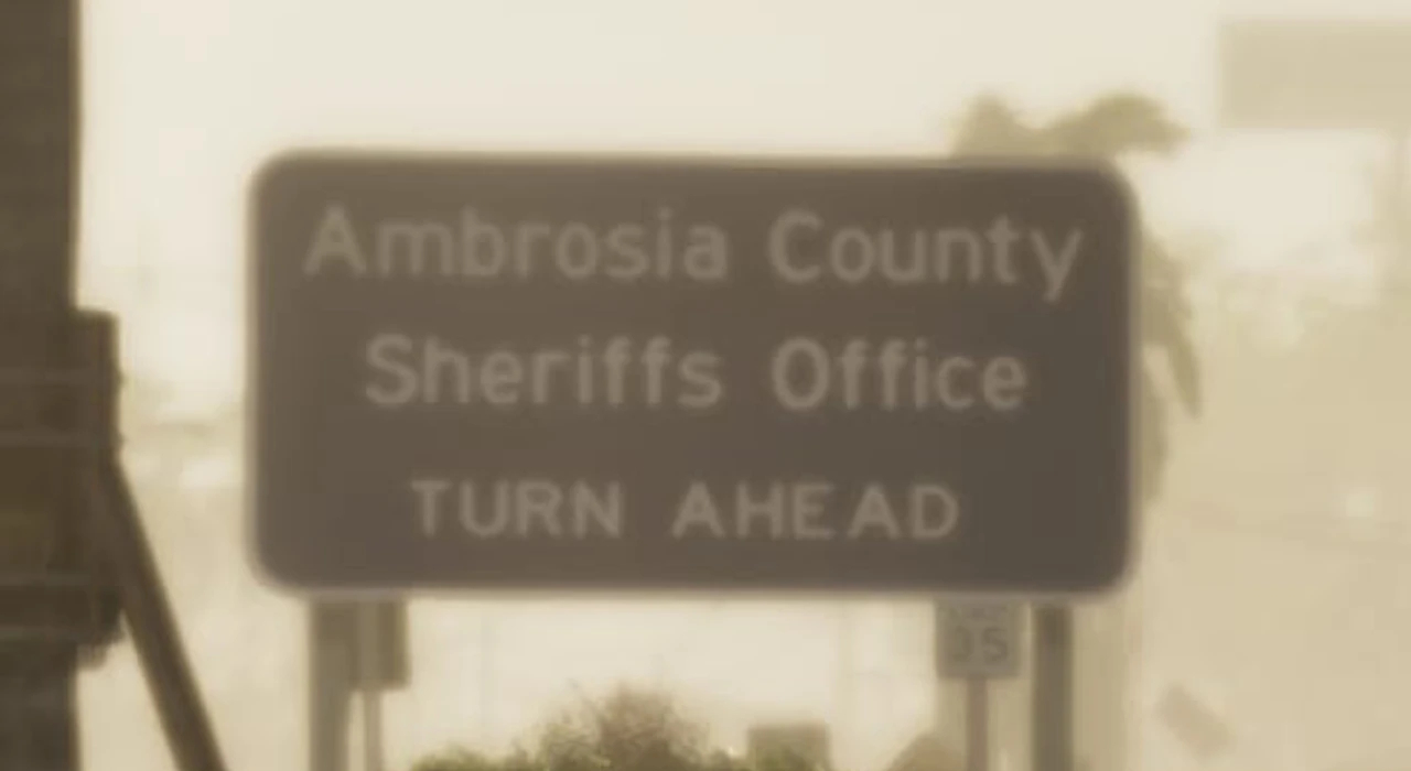 Дорожный знак с надписью Ambrosia County Sheriffs Office TURN AHEAD на фоне размытых силуэтов деревьев и зданий, ограничение скорости 35 миль в час.